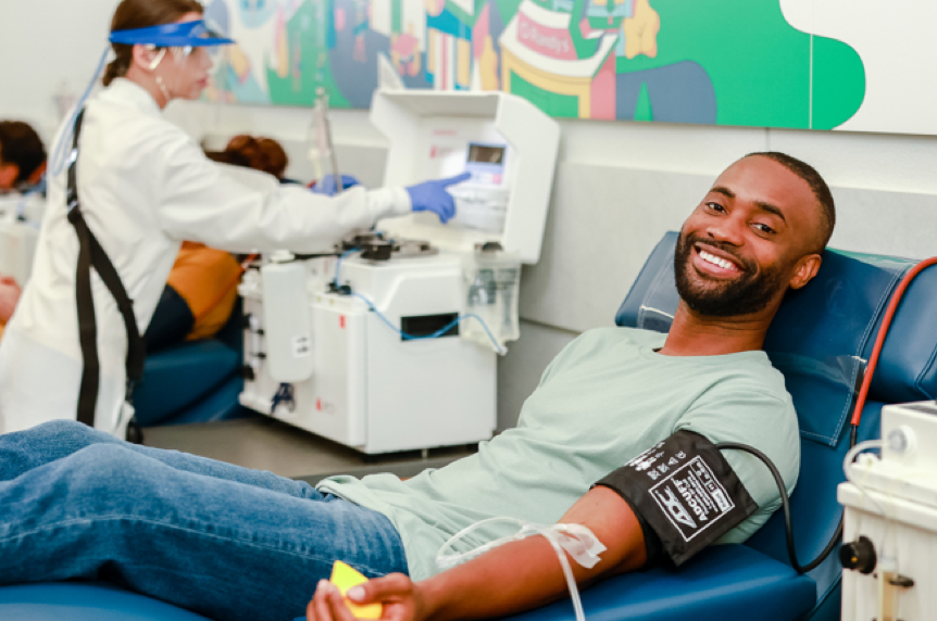 Young man laying down donating plasma